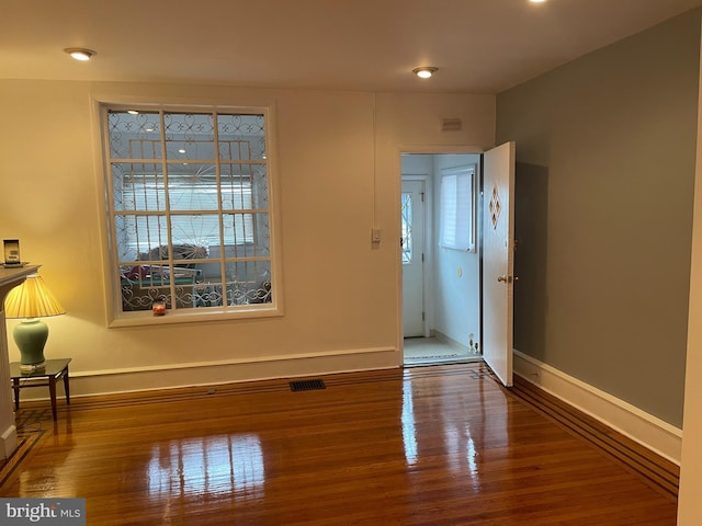 unfurnished room featuring dark hardwood / wood-style floors