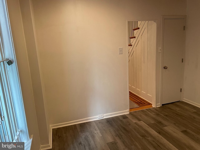 spare room with dark hardwood / wood-style floors