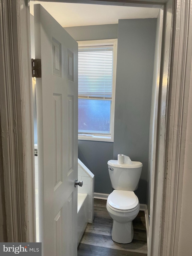 bathroom with toilet and hardwood / wood-style flooring