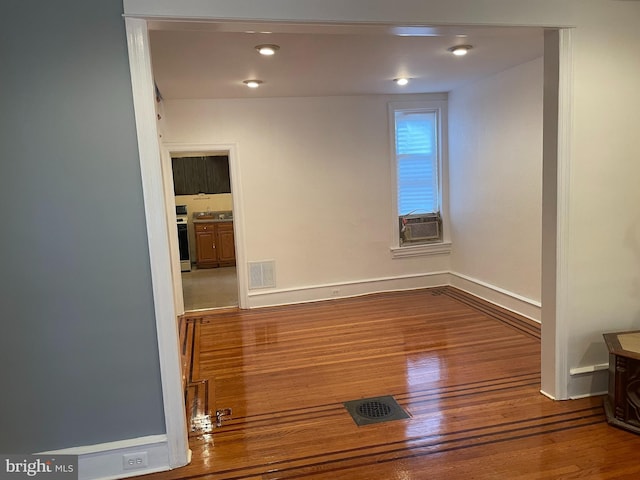 empty room with dark hardwood / wood-style flooring