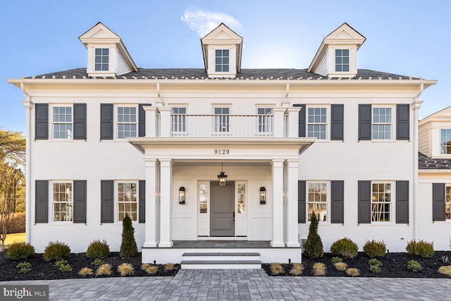 view of front of home with a porch and a balcony