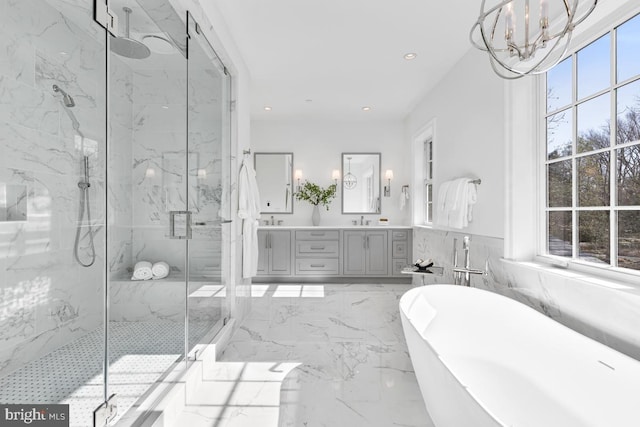 bathroom featuring tile flooring, vanity, a healthy amount of sunlight, and independent shower and bath