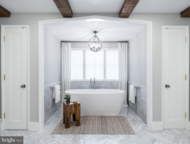 bathroom with beamed ceiling, tile flooring, and an inviting chandelier