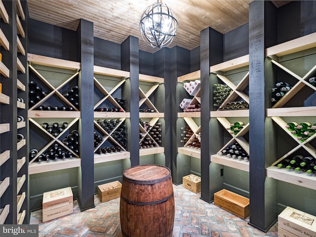 wine cellar featuring a notable chandelier and wood ceiling