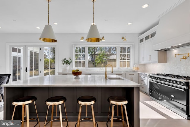 kitchen featuring backsplash, white cabinets, and sink