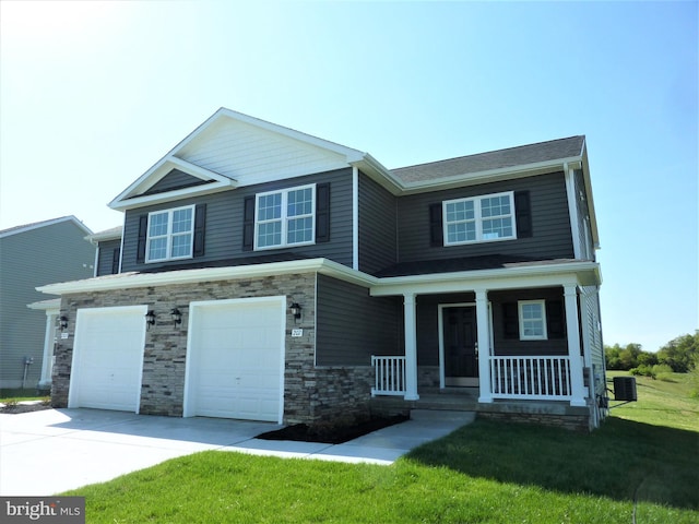 craftsman-style home with covered porch, central AC unit, a front lawn, and a garage