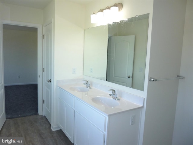 bathroom featuring double vanity and wood-type flooring