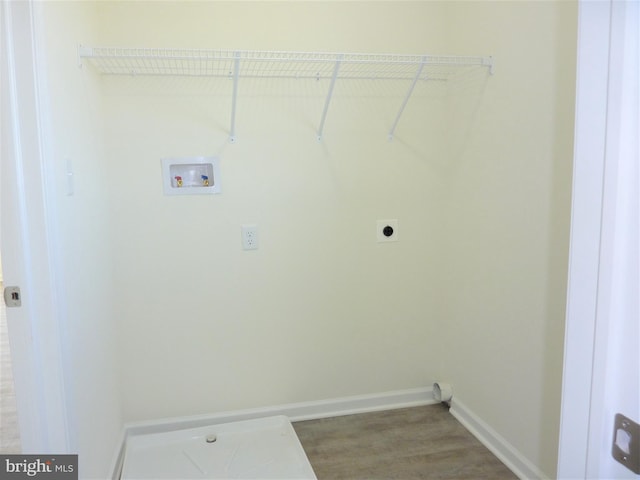 clothes washing area with light wood-type flooring, hookup for an electric dryer, and hookup for a washing machine