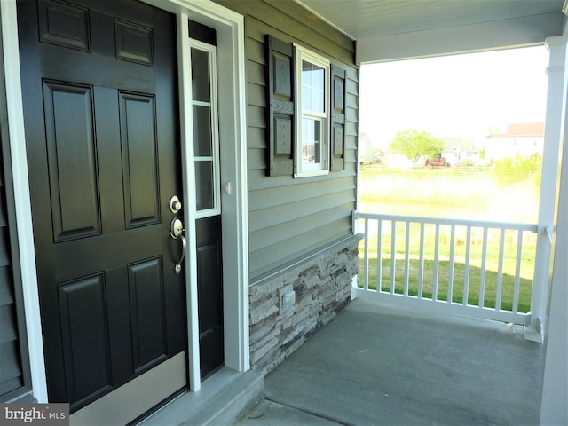 view of exterior entry with a porch