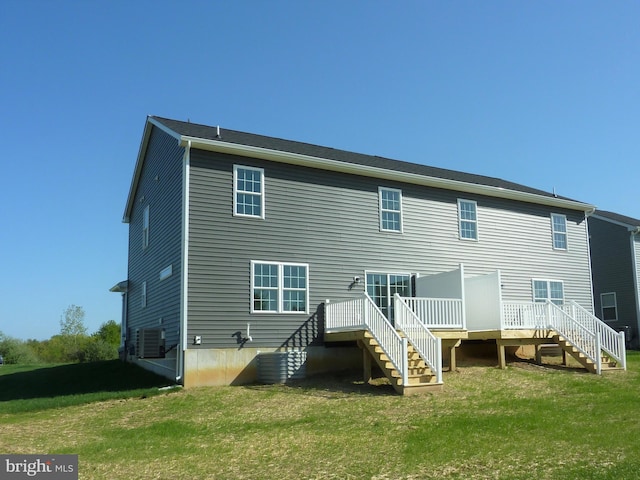 rear view of property featuring a yard