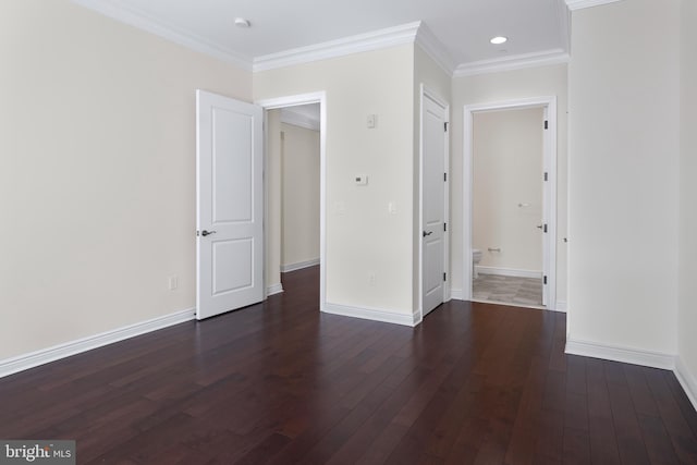 spare room with dark hardwood / wood-style flooring and ornamental molding