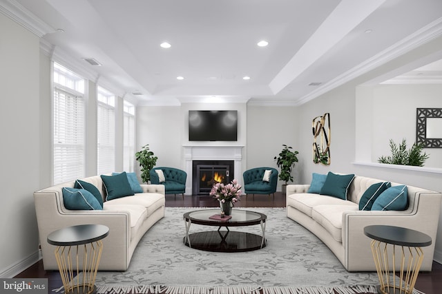 living room with crown molding, a tray ceiling, and light wood-type flooring