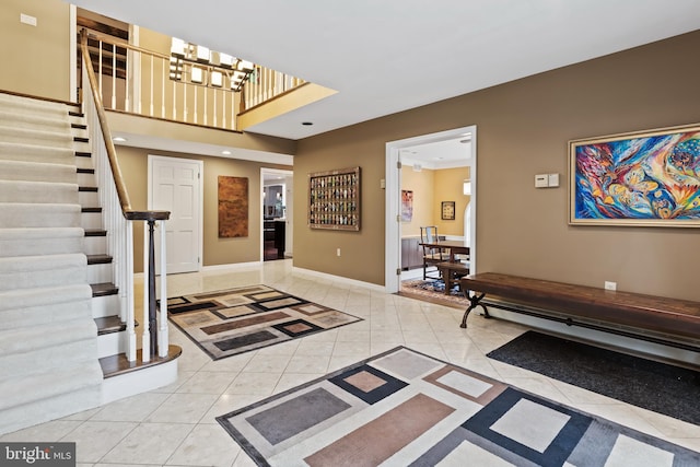 foyer with a notable chandelier and light tile floors