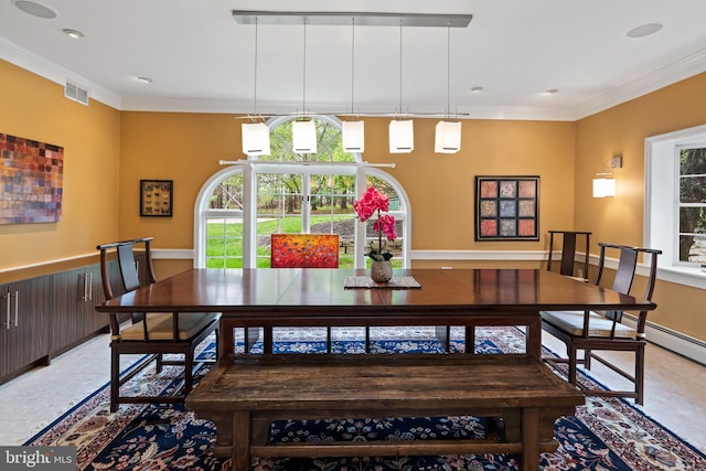 tiled dining room featuring crown molding