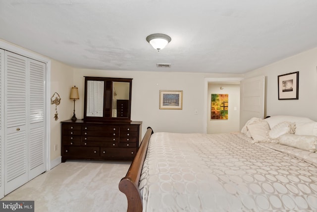 bedroom featuring light carpet and a closet