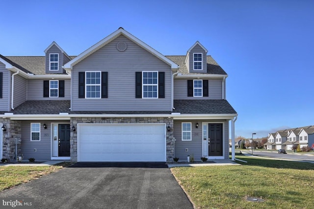 view of front of house with a front yard and a garage