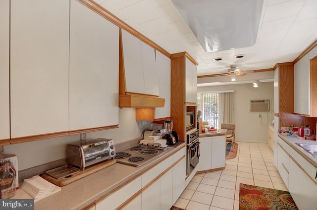 kitchen featuring white cabinets, premium range hood, stainless steel appliances, and ceiling fan