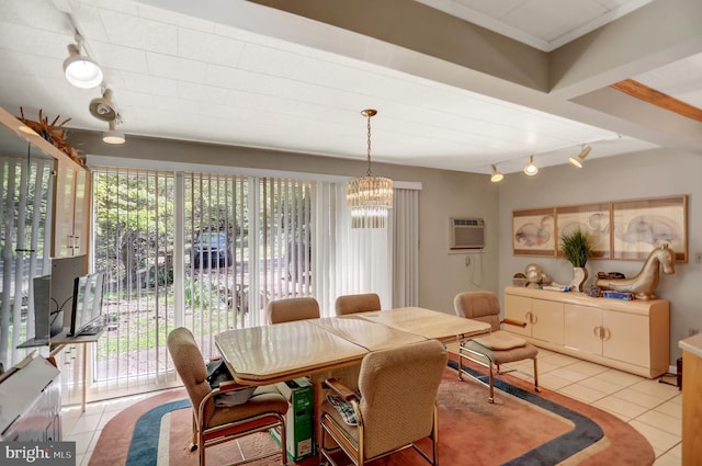 tiled dining space featuring a wall mounted air conditioner, a notable chandelier, track lighting, and a wealth of natural light