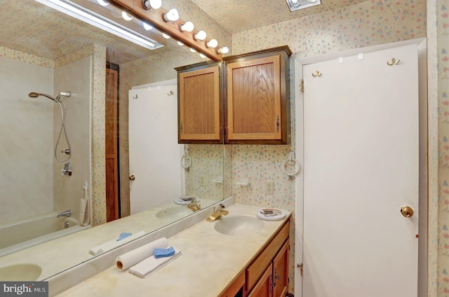 bathroom with bathing tub / shower combination and vanity