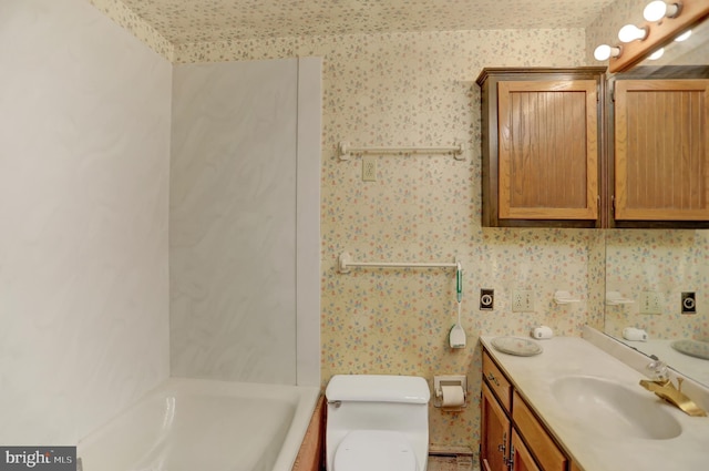 bathroom with vanity, a textured ceiling, and toilet