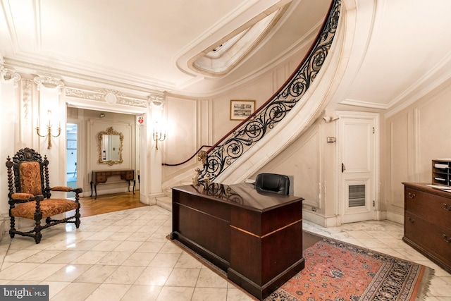 interior space with light hardwood / wood-style flooring, a tray ceiling, and ornamental molding