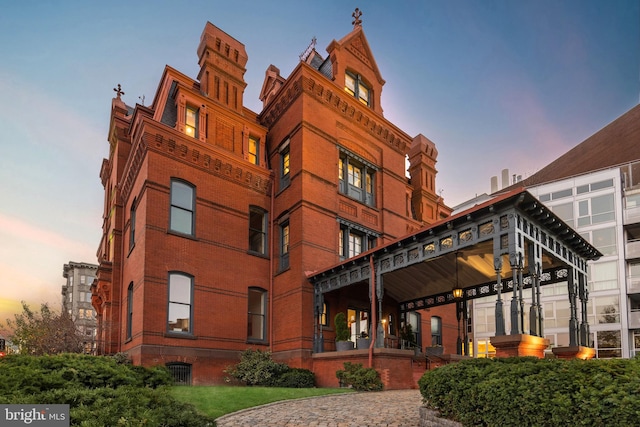 view of outdoor building at dusk