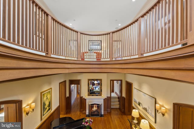 stairs with a towering ceiling and light hardwood / wood-style flooring