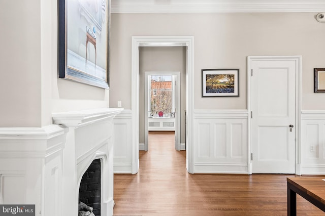 interior space featuring light wood-type flooring and ornamental molding