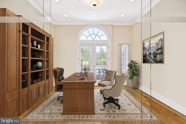 office space featuring french doors, ornamental molding, and light hardwood / wood-style floors