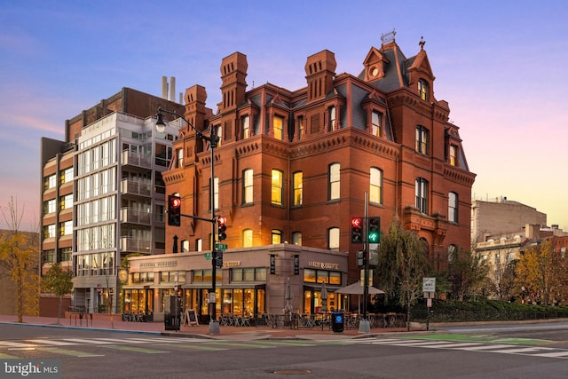 view of outdoor building at dusk