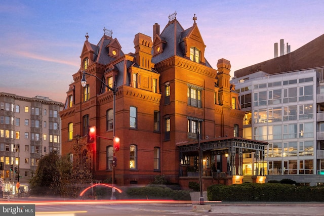 view of outdoor building at dusk