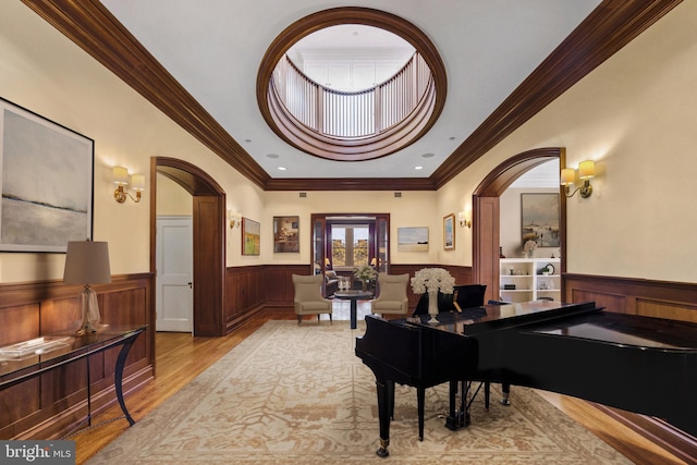 miscellaneous room with crown molding and light hardwood / wood-style flooring