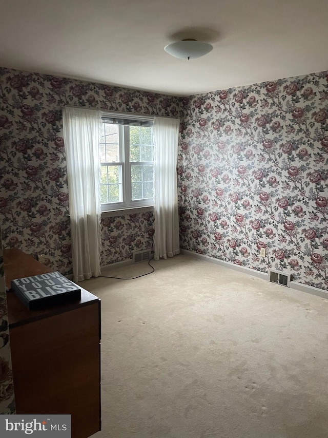 empty room featuring light colored carpet