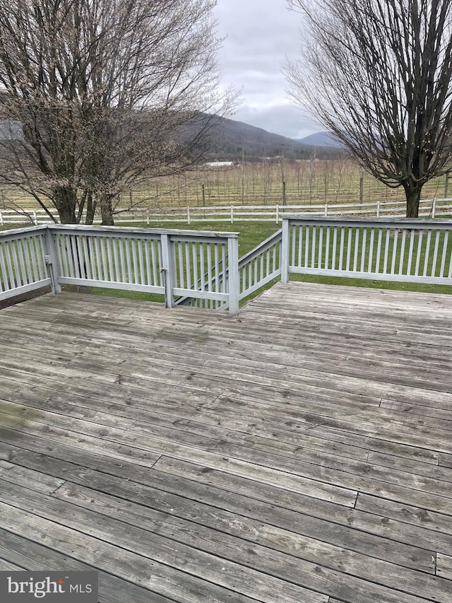 deck featuring a lawn and a mountain view