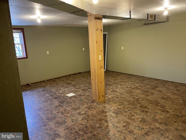 basement featuring dark tile flooring