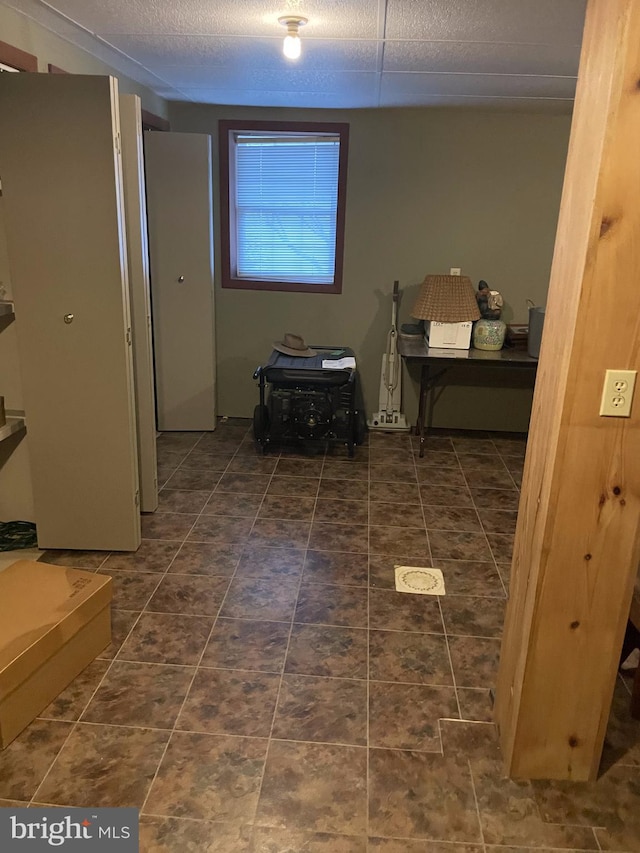 hallway featuring dark tile floors