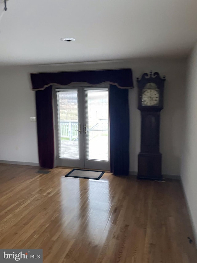 unfurnished room with dark hardwood / wood-style flooring and french doors