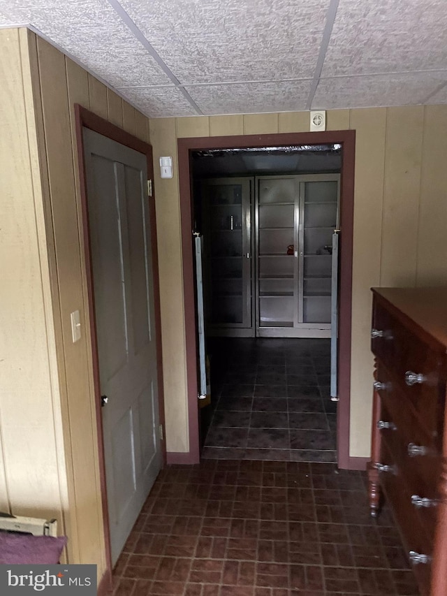 corridor featuring a paneled ceiling