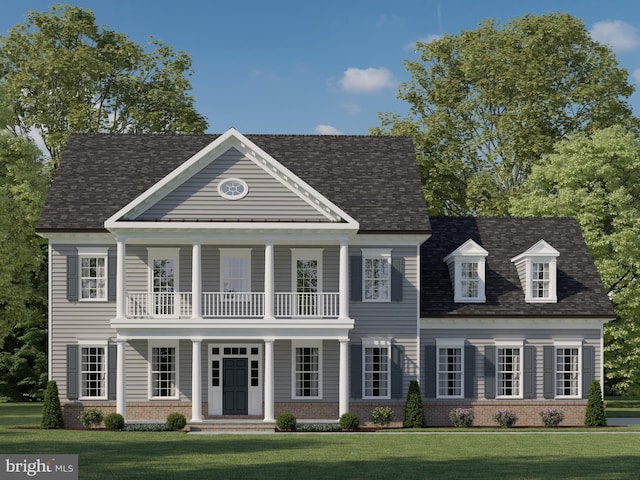 view of front of property featuring a balcony, covered porch, and a front yard