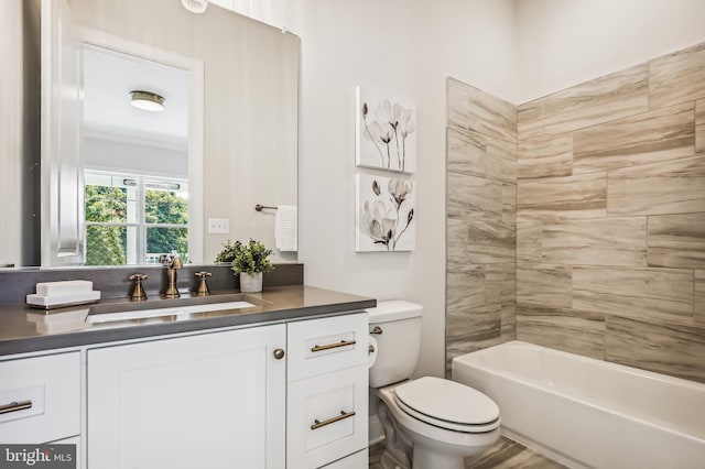 full bathroom with crown molding, toilet, vanity, and tiled shower / bath combo