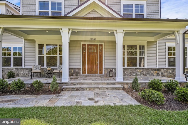 view of exterior entry with a porch