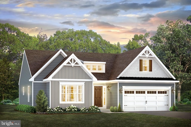 view of front of home featuring a lawn and a garage