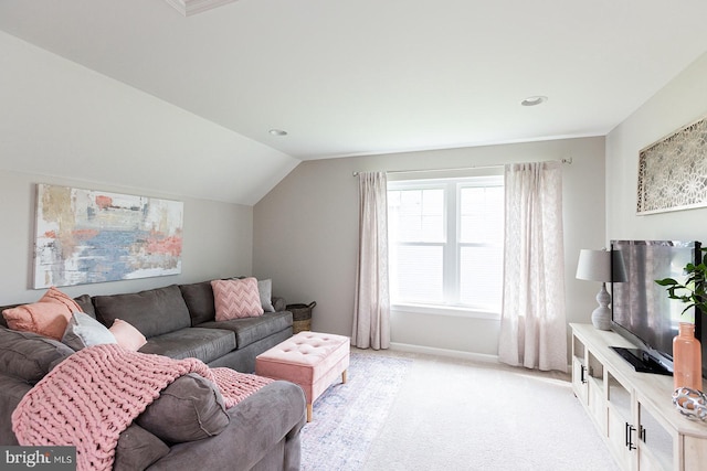 carpeted living room featuring lofted ceiling