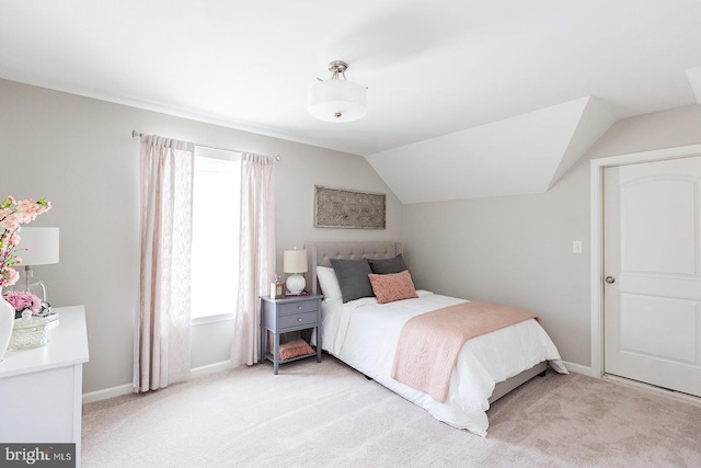 carpeted bedroom featuring vaulted ceiling