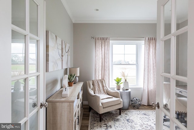 sitting room with crown molding, light hardwood / wood-style floors, and french doors