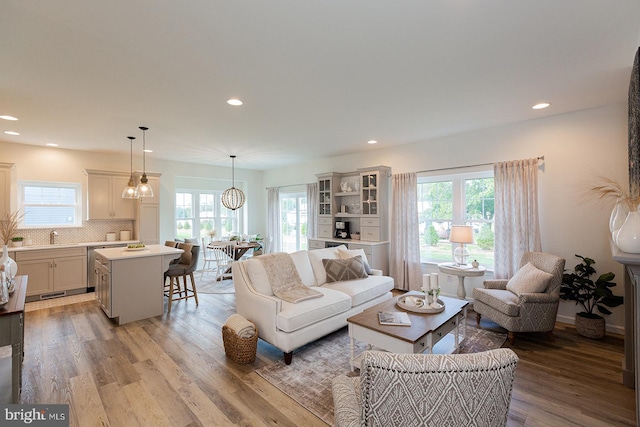 living room featuring light hardwood / wood-style floors and sink