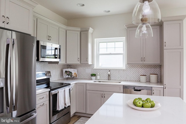 kitchen with backsplash, plenty of natural light, appliances with stainless steel finishes, and sink