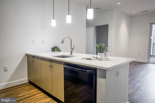 kitchen featuring dishwasher, dark wood-type flooring, sink, and pendant lighting