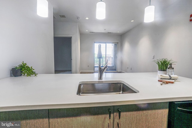 kitchen with dishwasher, hanging light fixtures, and sink