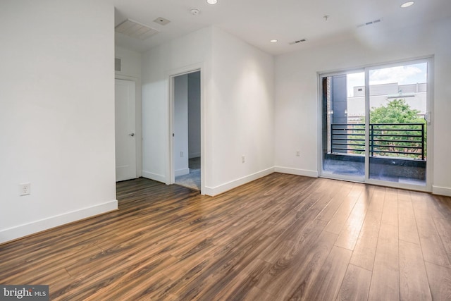 empty room featuring dark hardwood / wood-style flooring